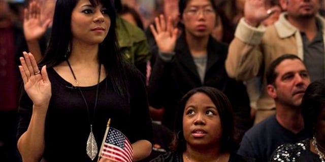 Dec. 15: Shyima Hall, left, takes the oath of citizenship during a citizenship ceremony in Montebello, Calif.