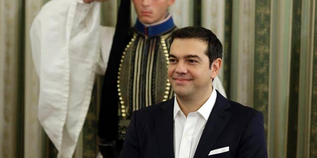Greece's Prime Minister Alexis Tsipras attends his cabinet's swearing in ceremony at the presidential palace in Athens, Wednesday, Sept. 23, 2015. Despite leftwing leader Alexis Tsipras' policy U-turn, he was re-elected by a wide margin in last weekend's general election, and again formed a coalition government with a small right-wing party, the Independent Greeks. (AP Photo/Thanassis Stavrakis)