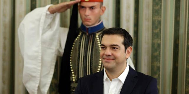 Greece's Prime Minister Alexis Tsipras attends his cabinet's swearing in ceremony at the presidential palace in Athens, Wednesday, Sept. 23, 2015. Despite leftwing leader Alexis Tsipras' policy U-turn, he was re-elected by a wide margin in last weekend's general election, and again formed a coalition government with a small right-wing party, the Independent Greeks. (AP Photo/Thanassis Stavrakis)