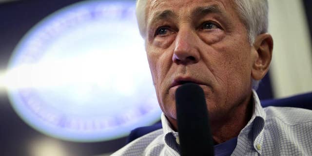 U.S. Defense Secretary Chuck Hagel speaks to members of a travel press pool, Friday, April 4, 2014, in flight, while en route to Tokyo, from Honolulu. Hagel is traveling to Japan, China and Mongolia. (AP Photo/Alex Wong, Pool)