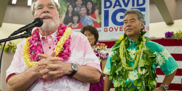 Saturday 9, 2014: Hawaii Governor Neil Abercrombie, left, addresses the supporters of Hawaii State Sen. David Ige as Ige, right, looks on. Ige defeated Abercrombie in the state's primary election to win the Democratic Party's nomination. (AP Photo/Eugene Tanner)