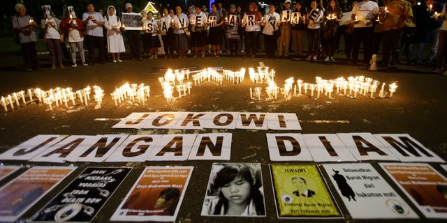 April 27, 2015 - Indonesian protesters gather with candles and banners that read " Save the Mary Jane, Jokowi (President Joko Widodo), Don't be silent" during a demonstration to demand the government to stop the execution of convicted Filipino Mary Jane Veloso, in Jakarta, Indonesia.