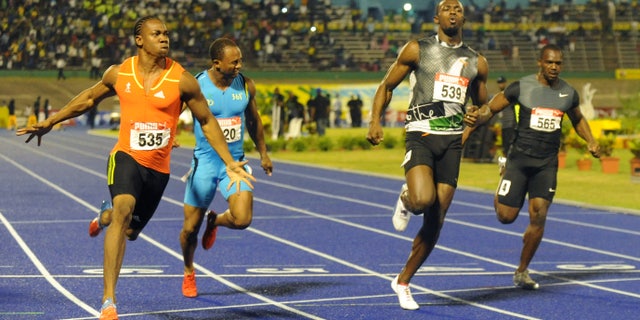 June 29, 2012: World champion Yohan Blake, left, celebrates after crossing the finish line ahead of current world-record holder Usain Bolt, second from right, Nesta Carter, right, and Michael Frater to win the 100m final at Jamaica's Olympic trials in Kingston, Jamaica.