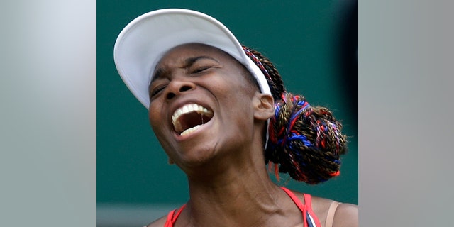 Venus Williams of the United States screams during her match against Aleksandra Wozniak of Canada at the All England Lawn Tennis Club in Wimbledon, London at the 2012 Summer Olympics, Tuesday, July 31, 2012. (AP Photo/Elise Amendola)