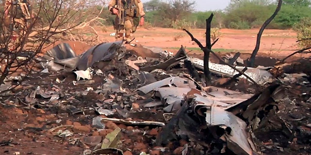 July 25, 2014: This photo provided by the French army shows soldiers at the site of the plane crash in Mali. (AP Photo/ECPAD)