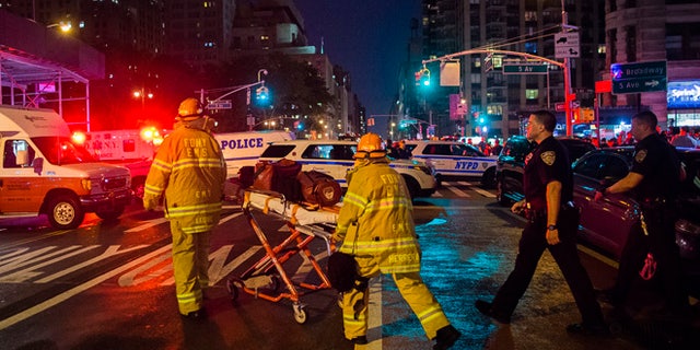 Police and firefighters work near the scene of an apparent explosion in Manhattan's Chelsea neighborhood, in New York, Saturday, Sept. 17, 2016. A law enforcement official tells The Associated Press that an explosion in the Chelsea neighborhood appears to have come from a construction toolbox in front of a building. The official spoke on condition of anonymity because the person wasn't authorized to speak about an ongoing investigation. More than two dozen people have sustained minor injuries in the explosion on West 23rd Street.(AP Photo/Andres Kudacki)
