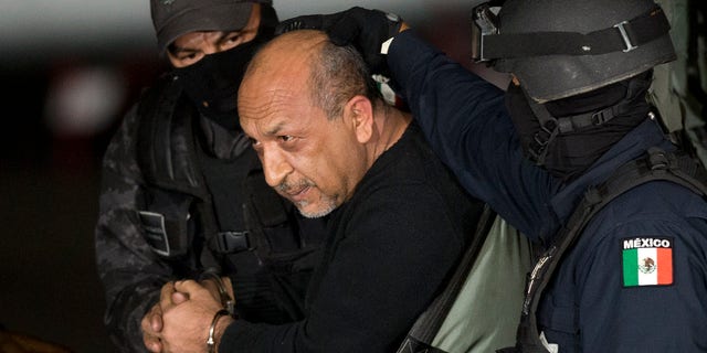 Servando "La Tuta" Gomez sits inside helicopter at a Federal hanger in Mexico City, Friday, Feb. 27, 2015.
