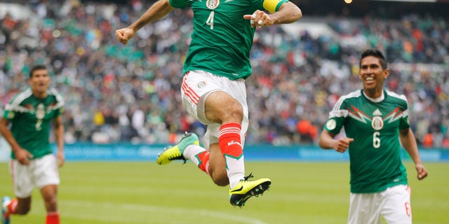 Mexico's Rafael Marquez celebrates after scoring his team's 5th goal during a 2014 World Cup playoff first round match against New Zealand in Mexico City, Wednesday, Nov. 13, 2013. (AP Photo/Eduardo Verdugo)