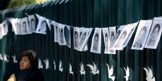 Images of the 43 students missing strung on the front gate of the Mexican attorney general's office in Mexico City.