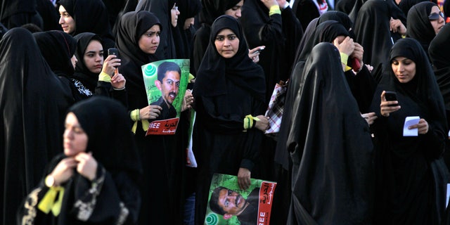 April 24: Anti-government protesters hold pictures of jailed political leader Abdulhadi al-Khawaja, who has been on a hunger strike for more than 70 days, during a march through Jidhafs, Bahrain.