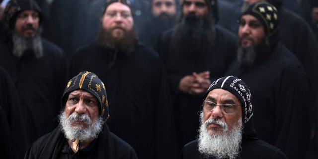 Clergymen gather to wait for the arrival of Egypt's Coptic Christian Pope Tawadros II, at the historic al-Muharraq Monastery, a centuries-old site some 180 miles (300 kilometers) south of Cairo in the province of Assiut, Egypt, Tuesday, Feb. 5, 2013. Egypt's Coptic Christian pope sharply criticized the country's Islamist leadership in an interview with The Associated Press on Tuesday, saying the new constitution is discriminatory and Christians should not be treated as a minority. (AP Photo/Khalil Hamra)