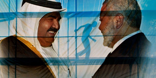 A Palestinian worker walks behind posters of the Emir of Qatar Sheikh Hamad bin Khalifa al-Thani, left, and Gaza's Hamas Prime Minister Ismail Haniyeh, right, in preparation for the visit to Gaza at Palestine stadium in Gaza City, Monday, Oct. 22, 2012.