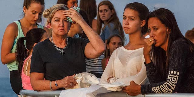 People gather during a candlelight vigil and paper balloon release at Jupiter Inlet Park, Monday, July 27, 2015, for teenagers Austin Stephanos and Perry Cohen in Jupiter, Fla.