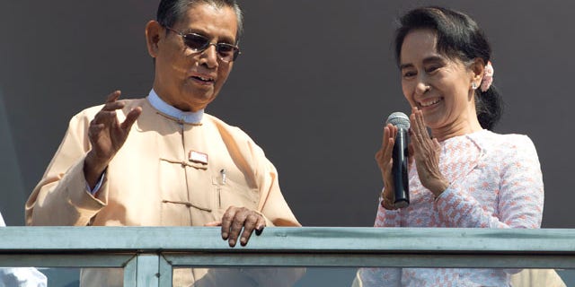 Nov. 9, 2015: Aung San Suu Kyi, the leader of Burma's National League for Democracy party, delivers a speech with party patron Tin Oo from a balcony of her party's headquarters in Yangon. (AP Photo/Mark Baker)