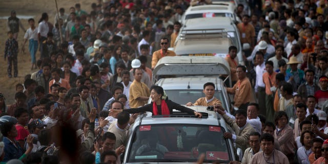 Nov. 30, 2012 - Opposition leader Aung San Suu Kyi reaches for supporters as she leaves after a public meeting close to Letpadaung mine in Monywa, northwestern Burma.