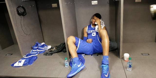 Kentucky guard Andrew Harrison sits in the locker room after his team's 60-54 loss to Connecticut in the NCAA Final Four tournament college basketball championship game Monday, April 7, 2014, in Arlington, Texas. (AP Photo/Eric Gay)