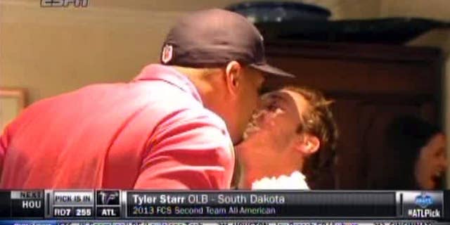 In this image taken from video, Missouri defensive end Michael Sam, left, gets a kiss at a draft party in San Diego, before he was selected in the seventh round, 249th overall, by the St. Louis Rams in the NFL draft Saturday, May 10, 2014. The Southeastern Conference defensive player of the year last season came out as gay in media interviews this year. (AP Photo/ESPN)