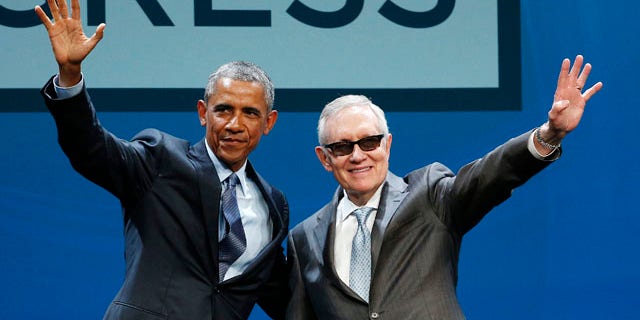 Aug. 24, 2015: President Barack Obama, left, and Senate Minority Leader Sen. Harry Reid wave onstage at the National Clean Energy Summit in Las Vegas. (AP Photo/John Locher)