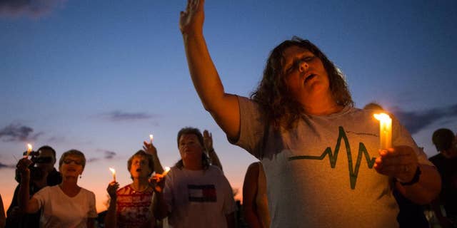 Stephanie Gray attends a vigil for journalists Alison Parker and Adam Ward who were killed during a shooting at Bridgewater Plaza in Moneta, Va., Wednesday, Aug. 26, 2015. Vester Lee Flanagan opened fire during a live on-air interview for WDBJ, killing the two journalists Wednesday. (Autumn Parry/The News & Advance via AP)