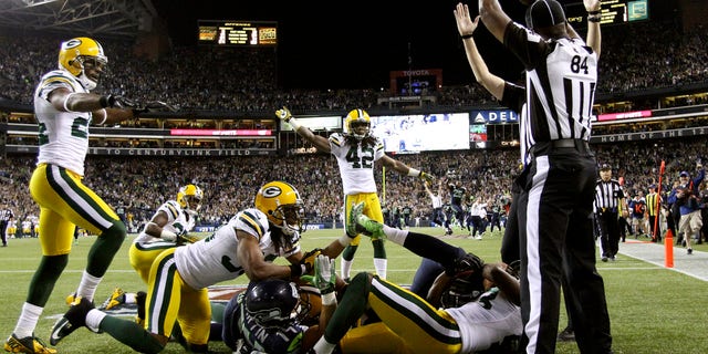 Sept. 24, 2012: Officials signal a touchdown after Seattle Seahawks wide receiver Golden Tate pulled in a last-second pass from quarterback Russell Wilson to defeat the Green Bay Packers 14-12 in an NFL football game.