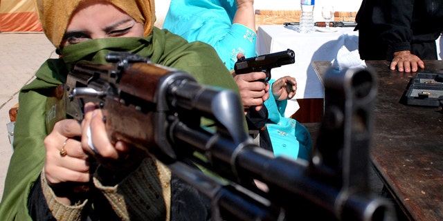 Jan. 27, 2015: A Pakistani teacher holds an weapon during a two-day training session by the police in Peshawar. (AP Photo/Mohammad Sajjad)