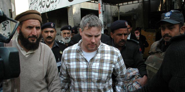 Jan. 28, 2011: Pakistani security officials escort Raymond Allen Davis, center, to a local court in Lahore, Pakistan. The Associated Press has learned that Davis, an American jailed in Pakistan after the fatal shooting of two armed men, was secretly working for the CIA.