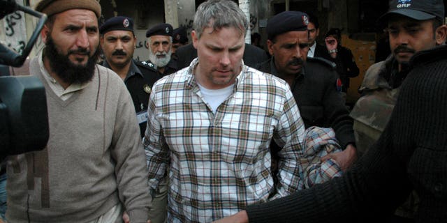Jan. 28, 2011: Pakistani security officials escort Raymond Allen Davis, center, to a local court in Lahore, Pakistan. The Associated Press has learned that Davis, an American jailed in Pakistan after the fatal shooting of two armed men, was secretly working for the CIA.
