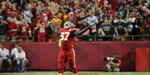 Kansas City Chiefs defensive end Allen Bailey celebrates after teammate Sean Smith intercepted a pass and ran it back 34-yards during the third quarter of an NFL football game against the New England Patriots, Monday, Sept. 29, 2014, in Kansas City, Mo. (AP Photo/Ed Zurga)