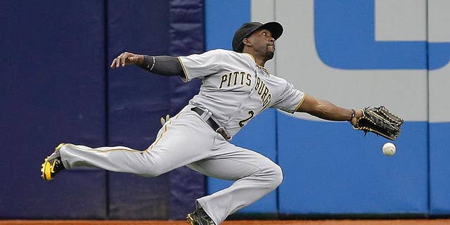 Pittsburgh Pirates center fielder Andrew McCutchen dives but can't make the catch on a triple by Tampa Bay Rays' Ben Zobrist during the first inning of an interleague baseball game Wednesday, June 25, 2014, in St. Petersburg, Fla. (AP Photo/Chris O'Meara)