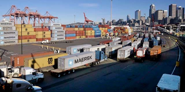 Feb. 17, 2015: Loaded container trucks line-up at a gate at the Port of Seattle. (AP Photo/Elaine Thompson)