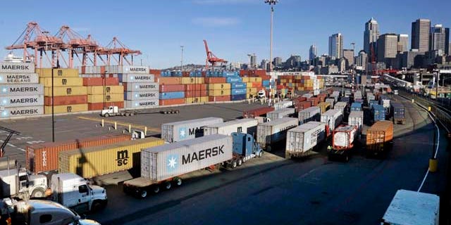 Feb. 17, 2015: Loaded container trucks line-up at a gate at the Port of Seattle. (AP Photo/Elaine Thompson)