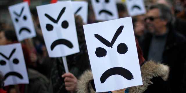 March 2, 2013: Demonstrators holding placards march down Lisbon's main Liberdade avenue during a protest against austerity measures taken by the Portuguese government in exchange of a euro 78 billion ($101 billion) international bailout needed in 2011.