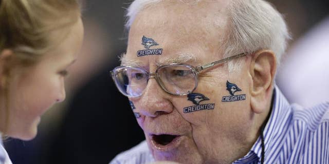 Billionaire investor Warren Buffett wears Creighton stickers before an NCAA basketball game.