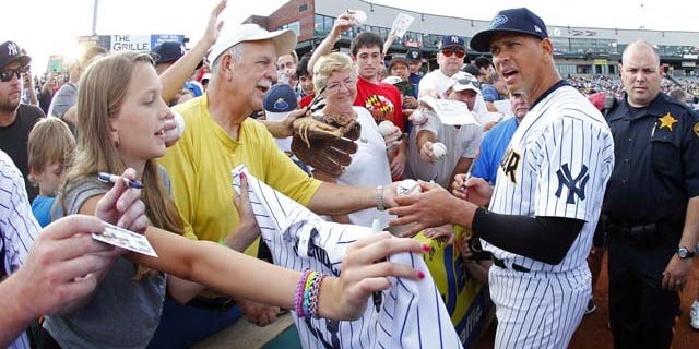 August 3, 2013: New York Yankees third baseman Alex Rodriguez signs autographs before a Class AA baseball game with the Trenton Thunder against the Reading Phillies in Trenton, N.J. (AP Photo)
