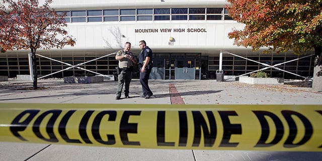 Police stand outside Mountain View High School after several students were stabbed inside the high school Tuesday, Nov. 15, 2016, in Orem, Utah Police say a 16-year-old boy was taken into custody after the stabbings. (AP Photo/Rick Bowmer)