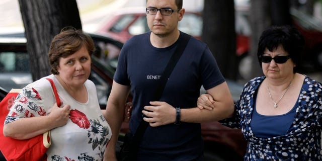 Goran Hadzic's son Srecko Hadzic, center, wife Zivka Hadzic, right and sister Goranka Meseldzija, arrive at the Special Court building in Belgrade, Serbia, Thursday, July 21, 2011.