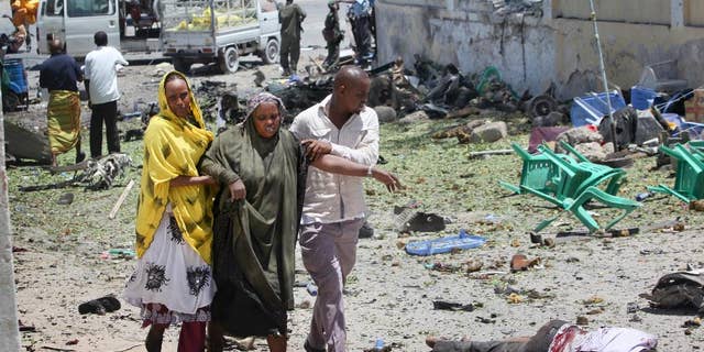 More than thirty people in Minnesota have been charged in recent years with conspiring to join terrorist groups such as ISIS and al-Shabab in Somalia. Here, people assist the wounded after an attack in Mogadishu, Somalia.