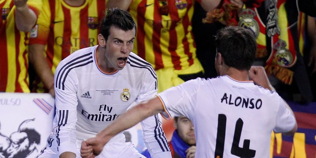 Real's Gareth Bale, left celebrates with Xabi Alonso on Wednesday, April 16, 2014.