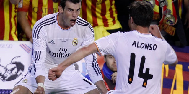 Real's Gareth Bale, left celebrates with Xabi Alonso on Wednesday, April 16, 2014.