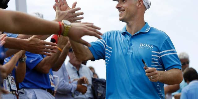 Ben Crane is congratulated after winning the St. Jude Classic golf tournament Sunday, June 8, 2014, in Memphis, Tenn. Crane won the tournament with a score of 10-under 270.(AP Photo/Mark Humphrey)