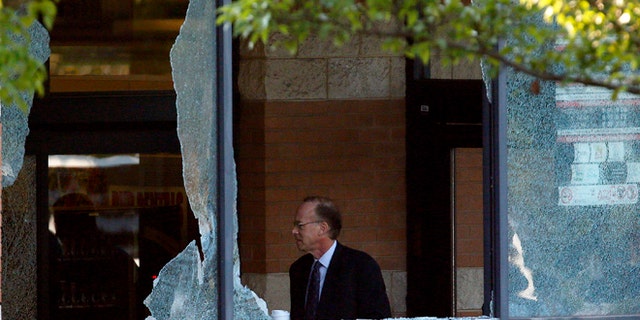 Aug. 31, 2012: Middlesex County prosecutor Bruce Kaplan inspects the scene of a shooting at a Pathmark grocery store in Old Bridge, N.J.