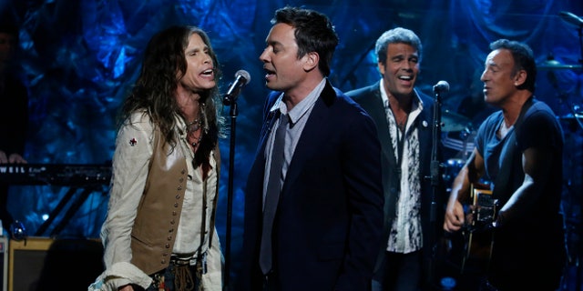 In this photo provided by NBC, from left, Steven Tyler, Jimmy Fallon, Mark Rivera, and Bruce Springsteen, perform during "Hurricane Sandy: Coming Together" Friday, Nov. 2, 2012, in New York. Hosted by Matt Lauer, the event is heavy on stars identified with New Jersey and the New York metropolitan area, which took the brunt of this week's deadly storm. (AP Photo/NBC, Heidi Gutman)