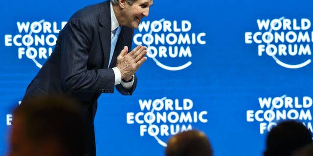 U.S. special presidential envoy for climate John Kerry bows to someone after his speech during a panel session at the World Economic Forum, in Davos, Switzerland, Friday, Jan. 23, 2015. (AP Photo/Michel Euler)