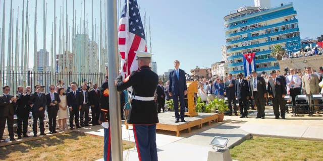 Aug. 14, 2015: Secretary of State John Kerry and other dignitaries watch as U.S. Marines raise the American Flag over the newly reopened embassy in Havana, Cuba