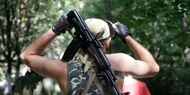 Aug. 6, 2014: A Pro-Russian rebel adjusts his weapon in Donetsk, eastern Ukraine. (AP)