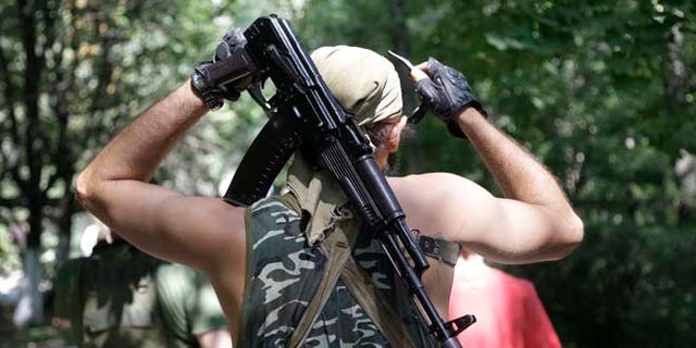 Aug. 6, 2014: A Pro-Russian rebel adjusts his weapon in Donetsk, eastern Ukraine. (AP)