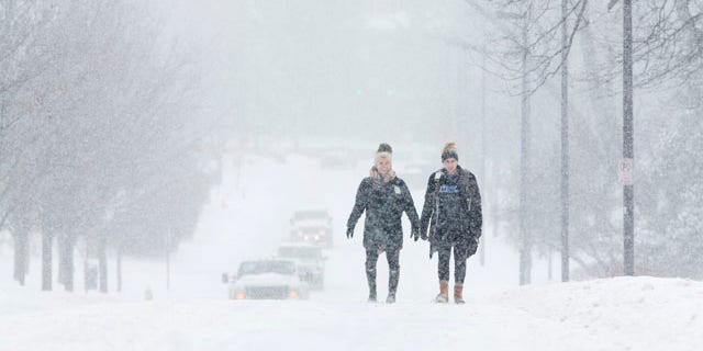 Feb. 16, 2015: University of Kentucky students Courtney Wiseman, left, and Abby Lerner walk home after studying on campus even as classes were canceled for the day in Lexington. (AP Photo/David Stephenson)