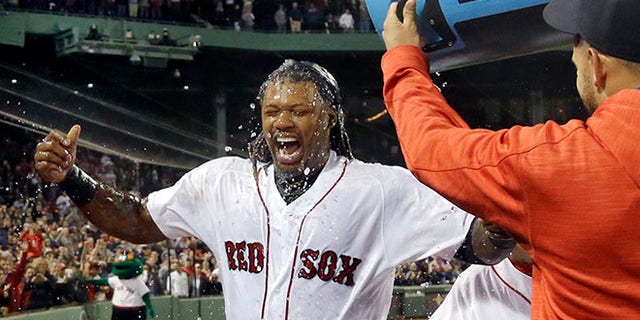 Boston Red Sox's Hanley Ramirez is doused by teammates on Thursday, Sept. 15, 2016, in Boston.