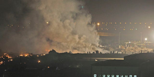 Sept. 3: Smoke rises from the site of a cargo plane crash in Dubai, United Arab Emirates. Officials say a UPS cargo plane with two crew members on board has crashed shortly after takeoff outside Dubai.