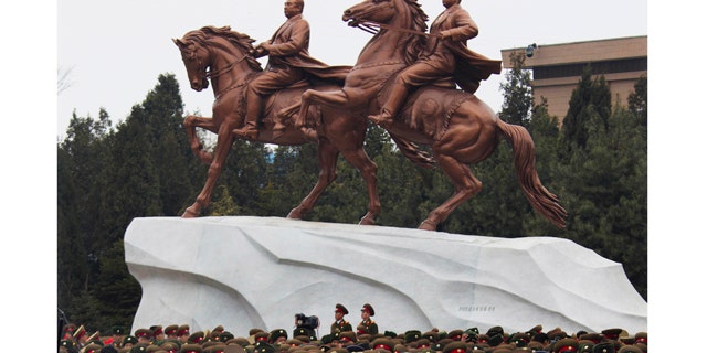Feb. 14,2012- North Koreans leave the grounds of the Mansudae Art Studio in Pyongyang after watching the unveiling of a new bronze statue depicting the late leader Kim Jong Il and his father Kim Il Sung. As North Koreans prepare for what would have been the 70th birthday of late leader Kim Jong Il this week, the country's state media have gone to great lengths to build up the man who led the nation for 17 years until his death in December.